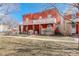 Classic brick home with a charming two-story porch and well-manicured front yard at 404 S Grant St, Denver, CO 80209