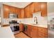 Beautiful kitchen with custom wood cabinets, stainless appliances, and stone countertops at 404 S Grant St, Denver, CO 80209