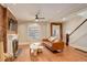 Spacious living room with hardwood floors, a fireplace, exposed brick, and a comfortable leather sofa at 404 S Grant St, Denver, CO 80209