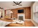 Cozy living room featuring exposed brick walls, a fireplace, hardwood floors, and modern furniture at 404 S Grant St, Denver, CO 80209