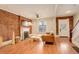 Bright living room with hardwood floors, exposed brick, a fireplace, and modern furnishings at 404 S Grant St, Denver, CO 80209