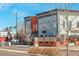 Street view of commercial buildings featuring modern architecture and outdoor seating areas at 404 S Grant St, Denver, CO 80209