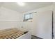 Bright bedroom with a white bed frame, large window, and built in storage shelf providing simple comfort at 219 Douglas Fir Ave, Castle Rock, CO 80104