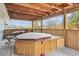 Enclosed deck with an above-ground jacuzzi and wrought iron furniture at 219 Douglas Fir Ave, Castle Rock, CO 80104