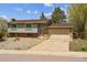 Charming split-level home with a two-car garage, well-maintained lawn, and a classic brick and siding facade at 219 Douglas Fir Ave, Castle Rock, CO 80104