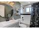 Well-lit bathroom with modern fixtures, subway tile, and a round mirror at 5945 W 86Th Ave, Arvada, CO 80003