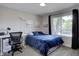 Comfortable bedroom featuring a large window, stylish curtains, and a work desk at 5945 W 86Th Ave, Arvada, CO 80003