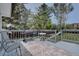 Outdoor deck with a table, grill, and chairs surrounded by trees, perfect for relaxation at 5945 W 86Th Ave, Arvada, CO 80003