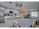 Well-lit kitchen with a large island, modern pendant lights, and stainless steel appliances at 5945 W 86Th Ave, Arvada, CO 80003