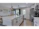 Modern kitchen featuring white cabinetry, stainless steel appliances, and a spacious island at 5945 W 86Th Ave, Arvada, CO 80003