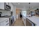 Stylish kitchen with stainless steel appliances, a mosaic backsplash, and light wood flooring at 5945 W 86Th Ave, Arvada, CO 80003