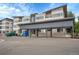 Apartment buildings with parking, carports, and attractive modern architecture at 1304 Snowberry # 203, Louisville, CO 80027
