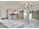 Bright, open living space flows into modern kitchen with stainless appliances and stylish light fixtures at 1304 Snowberry # 203, Louisville, CO 80027