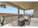 Covered back porch with comfortable seating and views of the backyard and community at 14551 Hudson St, Thornton, CO 80602