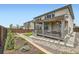 The backyard offers a deck, lawn, rock garden, and mature landscaping for outdoor enjoyment at 14551 Hudson St, Thornton, CO 80602