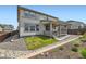 A great view of the backyard with a deck, lawn, and rock garden of a single Gathering house at 14551 Hudson St, Thornton, CO 80602