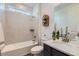Bright bathroom with a shower-over-tub, single sink vanity, and modern finishes at 14551 Hudson St, Thornton, CO 80602