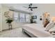 Inviting bedroom with ample natural light, a ceiling fan, plush carpet, and a modern aesthetic at 14551 Hudson St, Thornton, CO 80602