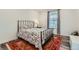 Cozy bedroom featuring a decorative bed, window with blinds, and stylish accents at 14551 Hudson St, Thornton, CO 80602