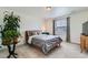 A cozy bedroom featuring neutral tones, a comfortable bed, and a lovely plant that adds a touch of nature indoors at 14551 Hudson St, Thornton, CO 80602