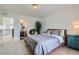 Comfortable bedroom featuring neutral decor and a view into the connected bathroom and loft space at 14551 Hudson St, Thornton, CO 80602