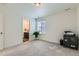 Clean bedroom featuring neutral decor and an adjacent bathroom visible with a plant at 14551 Hudson St, Thornton, CO 80602