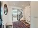 Bright foyer with hardwood floors, elegant staircase, and an open view to the living area at 14551 Hudson St, Thornton, CO 80602
