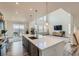 Bright kitchen with large center island, stainless appliances, and an adjacent living area at 14551 Hudson St, Thornton, CO 80602