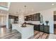 Modern kitchen with a large island, stainless steel appliances, and dark cabinetry at 14551 Hudson St, Thornton, CO 80602