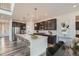 Stylish kitchen with dark cabinets, a large center island, and modern appliances at 14551 Hudson St, Thornton, CO 80602