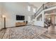 Open living room featuring hardwood floors, modern decor, a large rug, and a staircase at 14551 Hudson St, Thornton, CO 80602