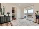 Open living area with hardwood floors and sliding glass door to the outdoor deck at 14551 Hudson St, Thornton, CO 80602