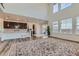 Open concept living area with soaring ceilings, bright windows and hardwood floors at 14551 Hudson St, Thornton, CO 80602