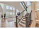 Modern staircase with hardwood floors and iron railings, leading to a bright, open living space at 14551 Hudson St, Thornton, CO 80602