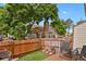 Cozy backyard deck with a grill, surrounded by a wood fence and lush greenery, providing privacy at 14396 E Temple Pl # D, Aurora, CO 80015