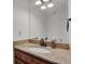 Bathroom with granite countertops, bronze fixtures, and a classic white sink at 14396 E Temple Pl # D, Aurora, CO 80015