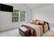 Bright bedroom features large windows, soft carpet, and a wall-mounted television at 14396 E Temple Pl # D, Aurora, CO 80015