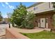 Charming brick building with a well-maintained lawn and mature trees, offering a welcoming entrance at 14396 E Temple Pl # D, Aurora, CO 80015
