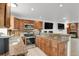 Traditional kitchen features granite counters, wood cabinets, and stainless steel appliances at 14396 E Temple Pl # D, Aurora, CO 80015