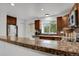 Stylish kitchen featuring granite countertops, stainless steel appliances, and natural light at 14396 E Temple Pl # D, Aurora, CO 80015