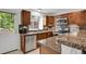 Well-appointed kitchen featuring granite countertops, stainless steel appliances, and ample cabinetry at 14396 E Temple Pl # D, Aurora, CO 80015