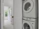 Hallway laundry area features stacked washer and dryer at 14396 E Temple Pl # D, Aurora, CO 80015