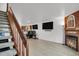 Open-concept living room with modern flooring and a staircase leading to the upper level at 14396 E Temple Pl # D, Aurora, CO 80015