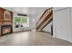 Cozy living room with a fireplace, staircase, and a view of the outdoors at 14396 E Temple Pl # D, Aurora, CO 80015