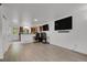Bright living area with wood-look floors, creating a versatile space for living and dining at 14396 E Temple Pl # D, Aurora, CO 80015