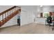 Spacious living room featuring stairs, storage, and connection to the kitchen at 14396 E Temple Pl # D, Aurora, CO 80015