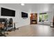 Comfortable living area with a fireplace, modern entertainment setup, and ample natural light at 14396 E Temple Pl # D, Aurora, CO 80015