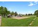 Community sand volleyball court surrounded by green lawns, ideal for outdoor recreation and neighborhood gatherings at 14396 E Temple Pl # D, Aurora, CO 80015