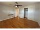 Bright bedroom featuring hardwood floors, a ceiling fan, closet, and built-in desk at 4670 Independence St, Wheat Ridge, CO 80033