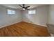 Bedroom with hardwood floors, two windows, and a ceiling fan at 4670 Independence St, Wheat Ridge, CO 80033
